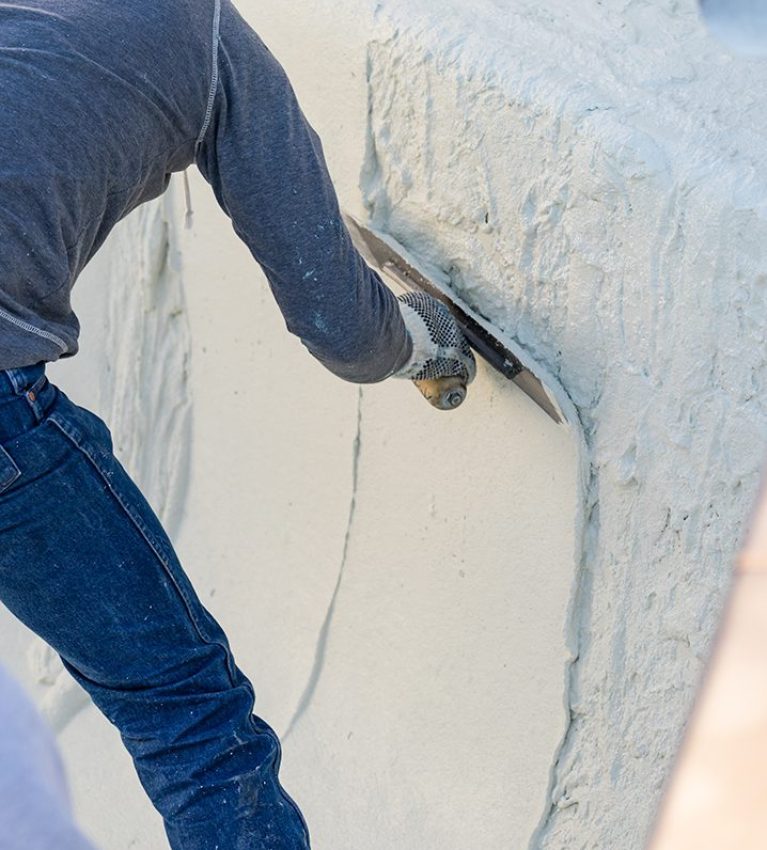 Worker Smoothing Wet Pool Plaster With Trowel.