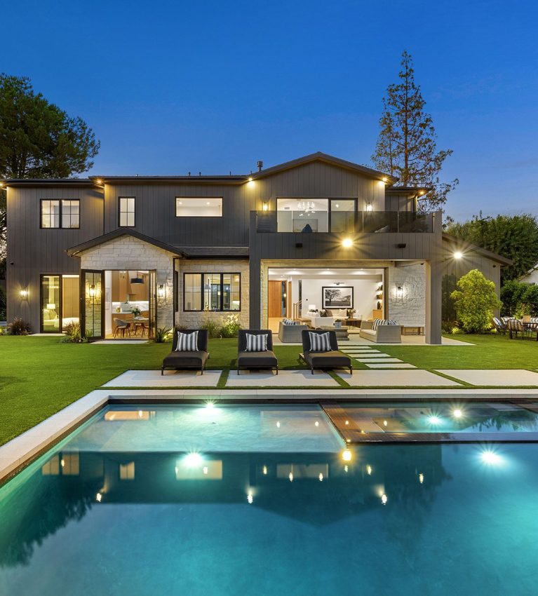 Luxurious modern house with pool at twilight.